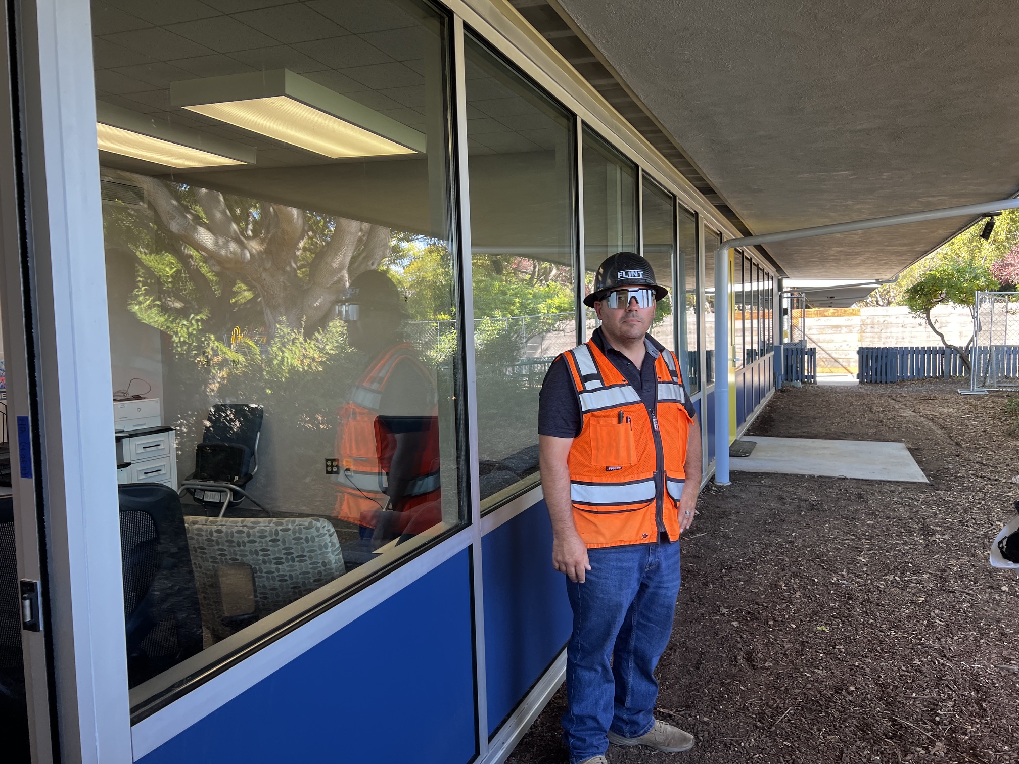 Contractor walking through the completed work outside a classroom