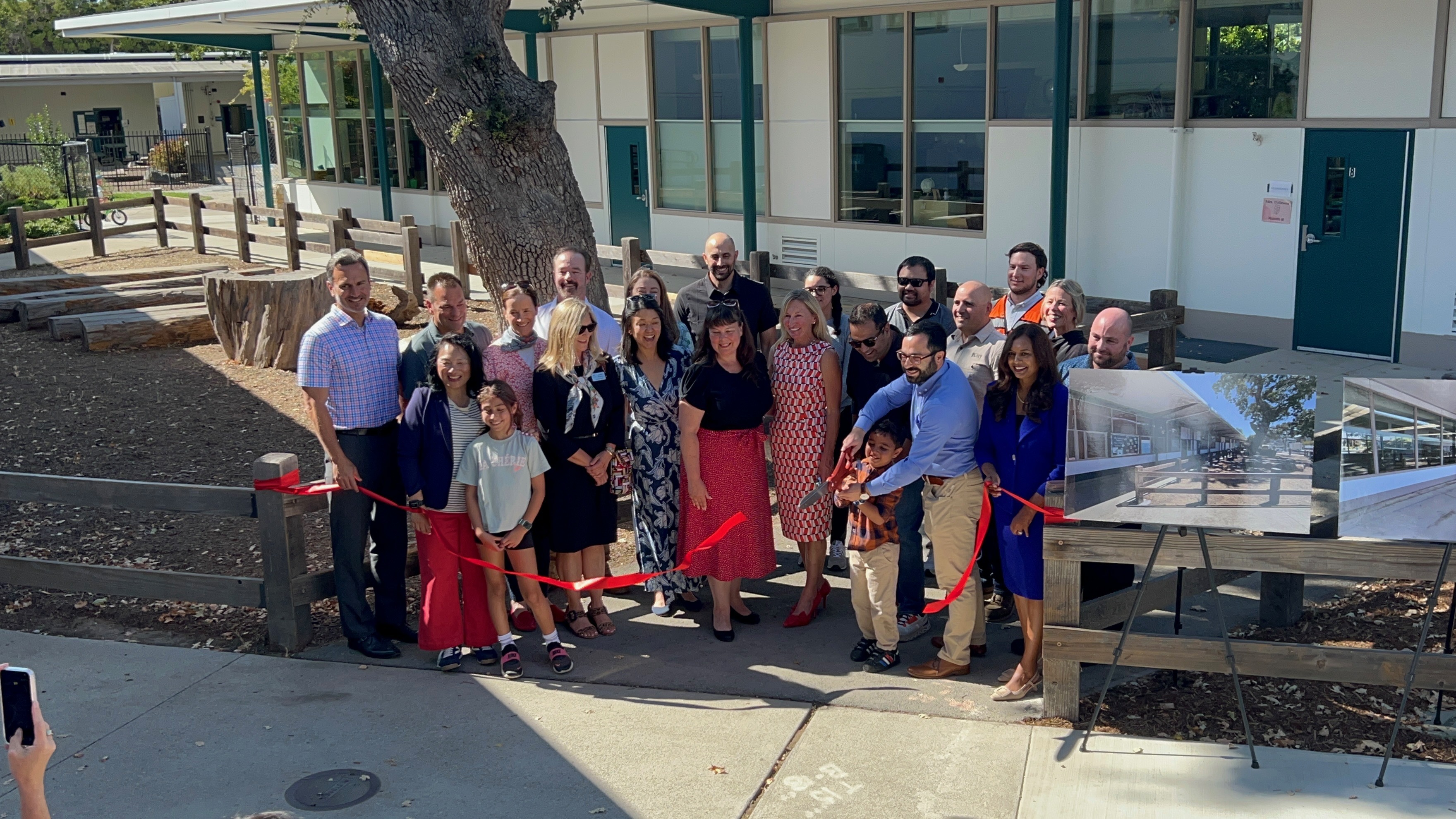 Group photo at the ribbon cutting with City Council members, Supervisor Mueller, and school staff